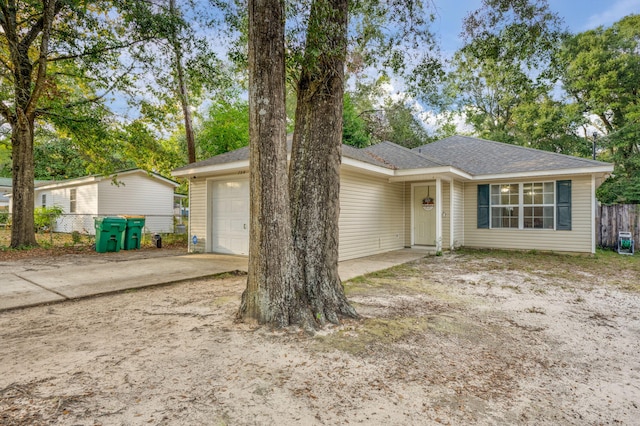 706 Brock Ave, Crestview, FL 32539 - ranch-style home featuring an attached garage, driveway, roof with shingles, and fence