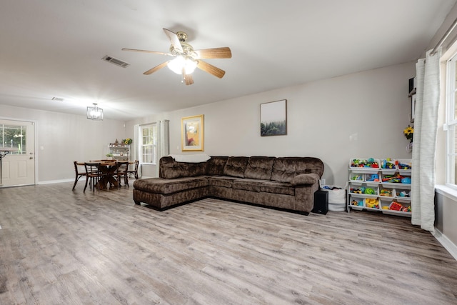 living room with light hardwood / wood-style floors and ceiling fan