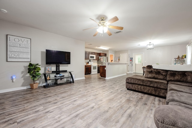 706 Brock Ave, Crestview, FL 32539 - living area with light wood-style floors, baseboards, and a ceiling fan