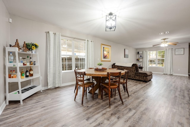 dining space featuring light wood-type flooring and ceiling fan