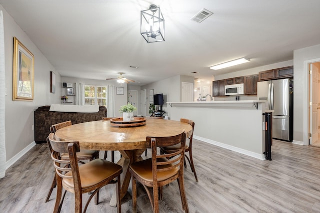 dining area featuring light hardwood / wood-style flooring and ceiling fan