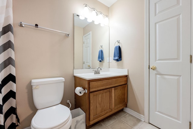 bathroom with vanity, toilet, and tile patterned flooring