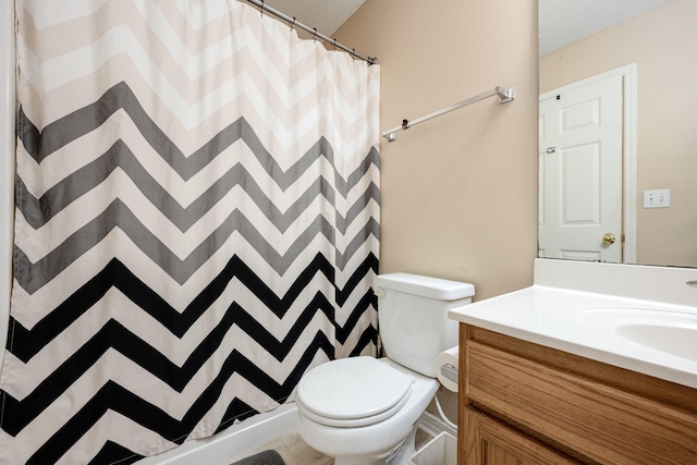 bathroom featuring vanity, toilet, and a shower with shower curtain