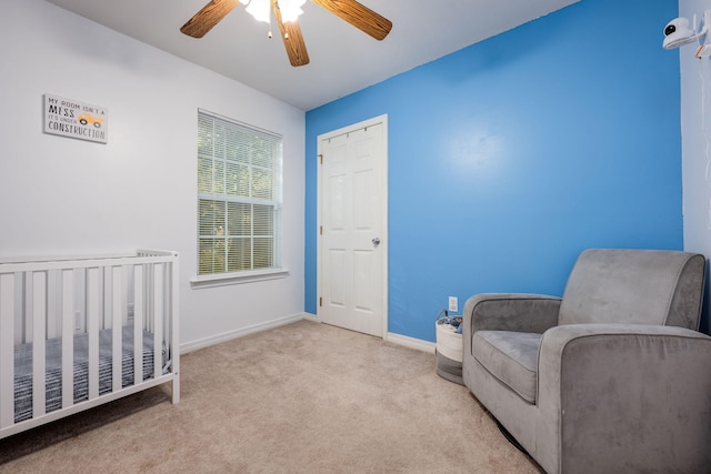 706 Brock Ave, Crestview, FL 32539 - carpeted bedroom with baseboards, ceiling fan, and a crib