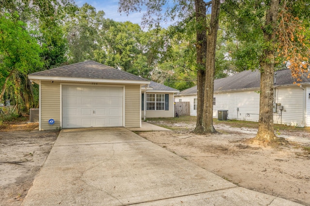 706 Brock Ave, Crestview, FL 32539 - ranch-style house featuring concrete driveway, cooling unit, a detached garage, and roof with shingles
