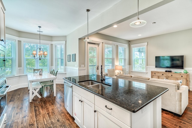 kitchen with a wealth of natural light, sink, white cabinetry, and pendant lighting