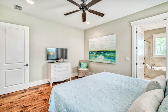 bedroom with ensuite bath, hardwood / wood-style floors, and ceiling fan