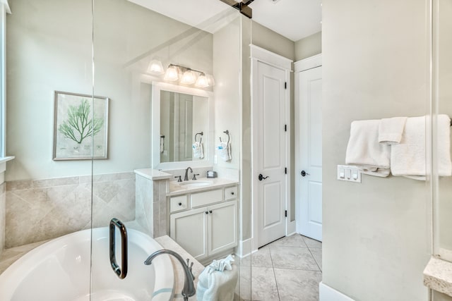 bathroom with vanity, tile patterned floors, and a bathing tub