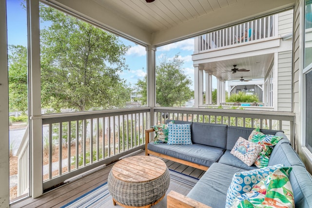 sunroom with ceiling fan, wooden ceiling, and a wealth of natural light