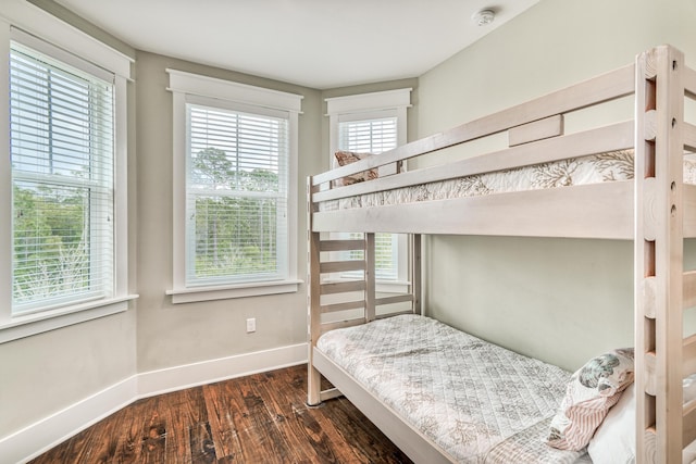 bedroom with dark hardwood / wood-style flooring