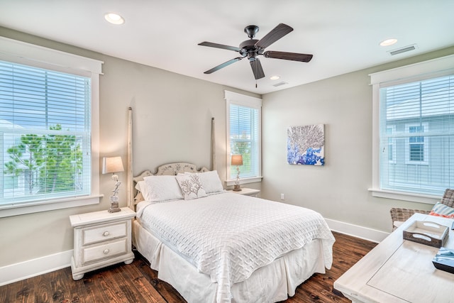 bedroom with dark hardwood / wood-style flooring and ceiling fan