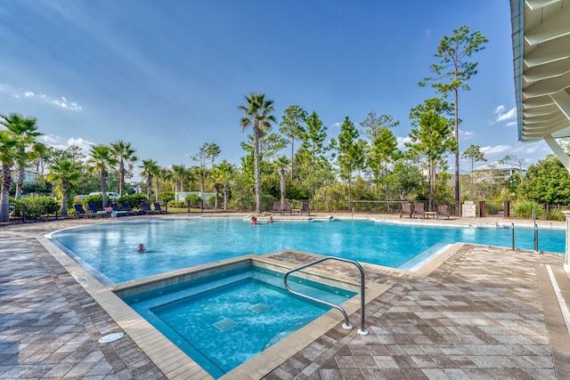 view of swimming pool with a patio and a hot tub