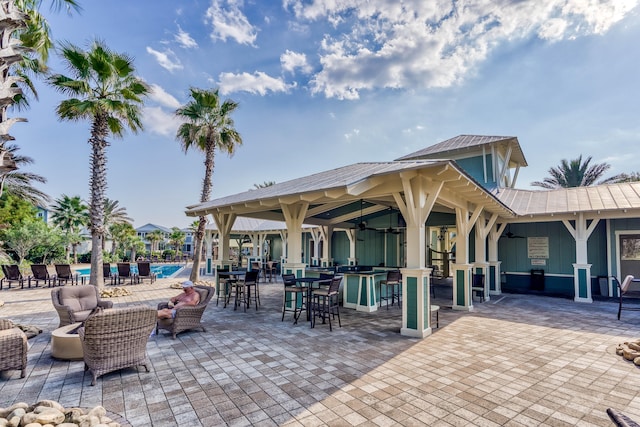 view of patio featuring a community pool and ceiling fan