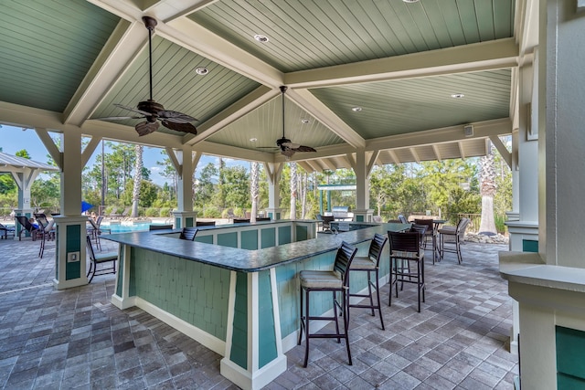 view of patio with an outdoor bar and ceiling fan