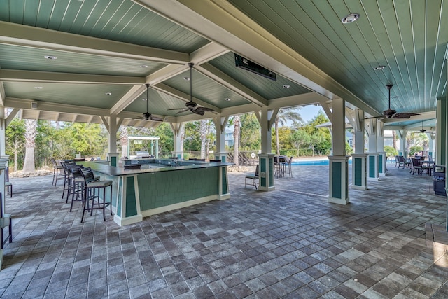 view of patio featuring an outdoor bar and ceiling fan