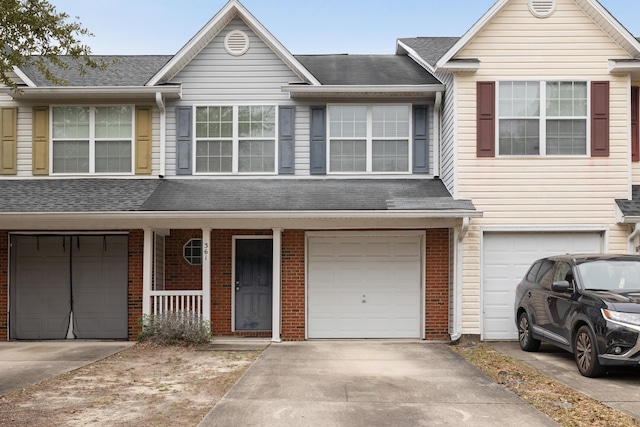 view of property featuring covered porch and a garage