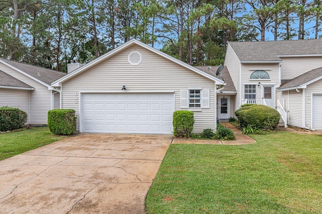 view of front of property with a garage and a front lawn