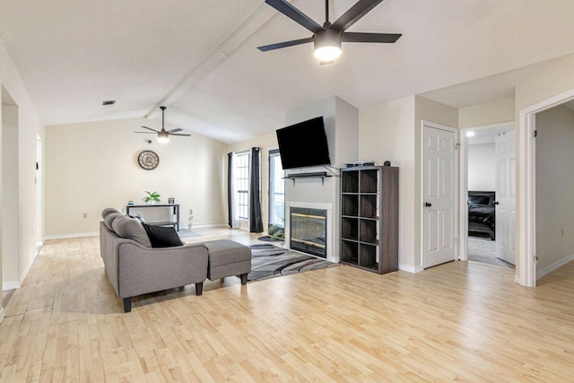 living room with lofted ceiling with beams, ceiling fan, and light hardwood / wood-style floors