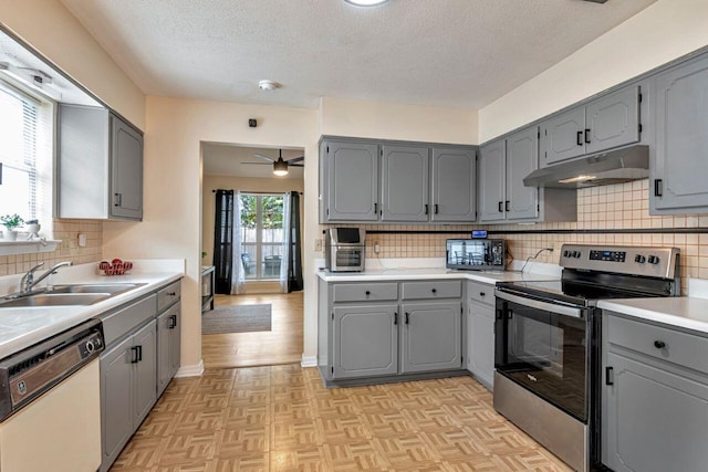 kitchen featuring ceiling fan, backsplash, white dishwasher, and stainless steel electric stove