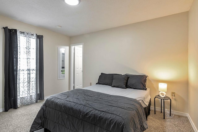 carpeted bedroom featuring a textured ceiling