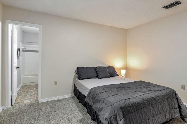 bedroom featuring carpet flooring, a textured ceiling, and connected bathroom