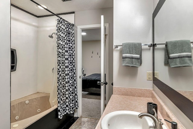 bathroom with vanity, shower / bath combo with shower curtain, and a textured ceiling