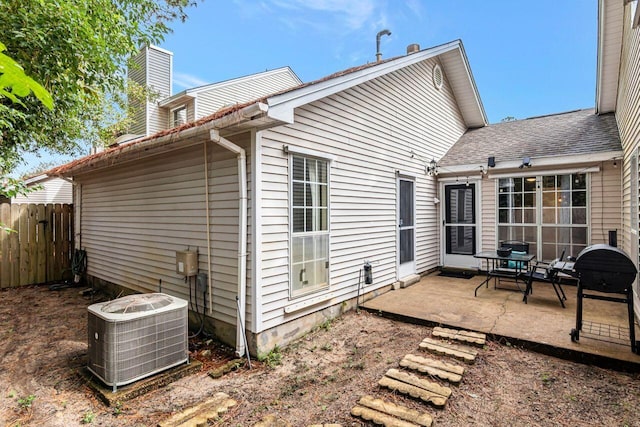 rear view of house with a patio and cooling unit