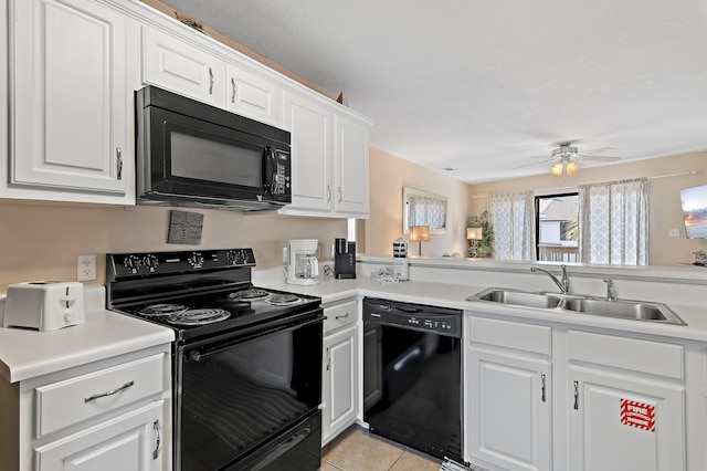 kitchen with light tile patterned flooring, white cabinets, black appliances, and sink