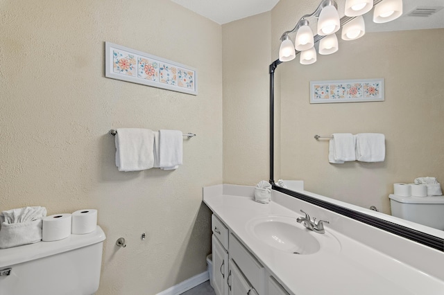 bathroom featuring toilet and vanity