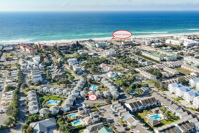 drone / aerial view with a water view and a beach view