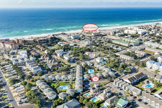 birds eye view of property featuring a water view and a beach view