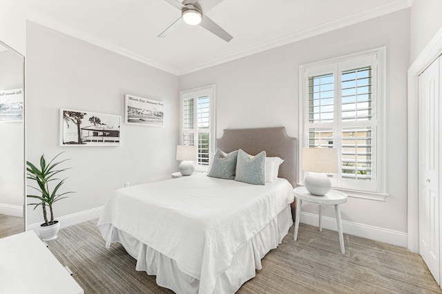 carpeted bedroom featuring a closet, multiple windows, and ceiling fan