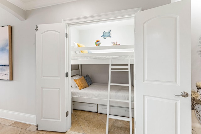 tiled bedroom featuring ornamental molding