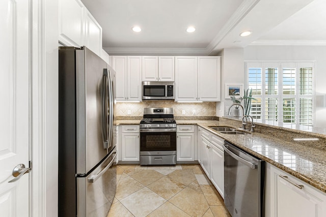 kitchen featuring crown molding, sink, appliances with stainless steel finishes, light stone counters, and white cabinetry