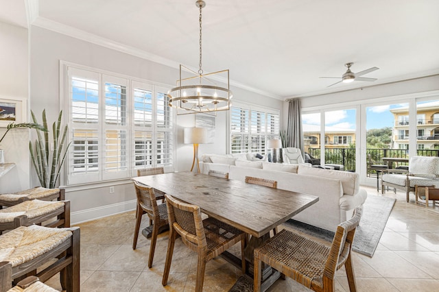 tiled dining room with ceiling fan with notable chandelier, crown molding, and a wealth of natural light