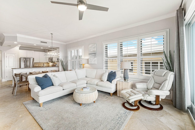 living room featuring plenty of natural light, ornamental molding, and ceiling fan