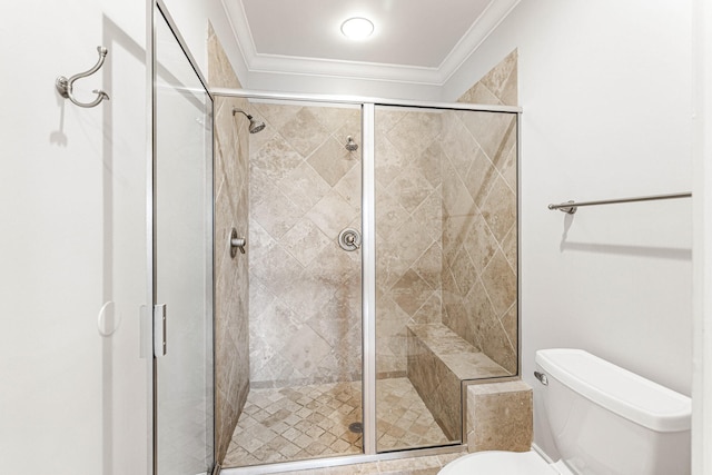 bathroom with toilet, an enclosed shower, and ornamental molding