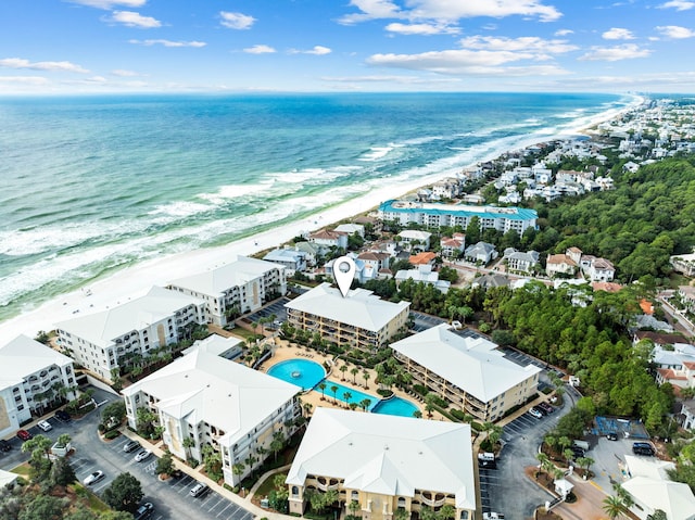 birds eye view of property with a beach view and a water view