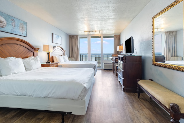 200 N Sandestin Blvd Unit 6772, Miramar Beach, FL 32550 - bedroom with access to exterior, a textured ceiling, wood-type flooring, and track lighting