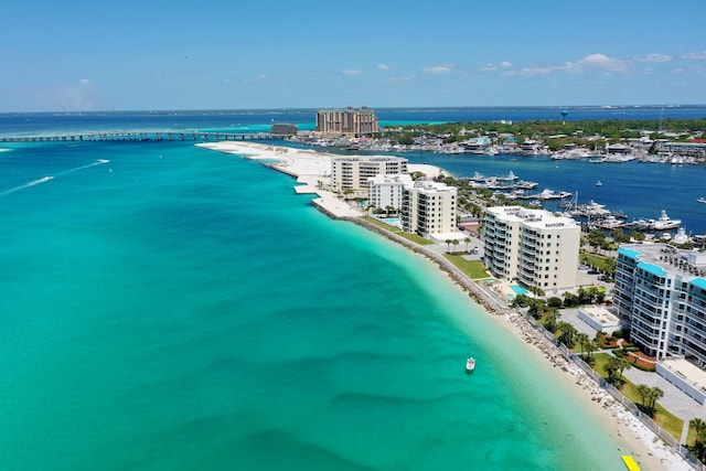 birds eye view of property featuring a water view and a beach view