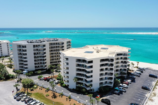 bird's eye view featuring a water view and a beach view