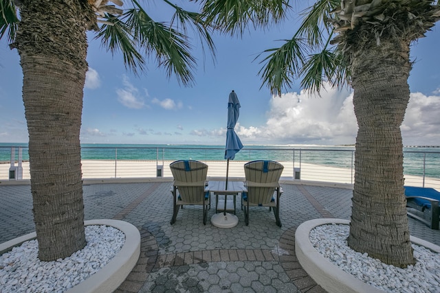 view of patio / terrace featuring a view of the beach and a water view