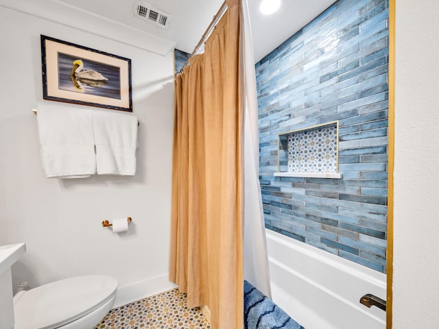 bathroom featuring toilet, shower / tub combo, and tile patterned flooring