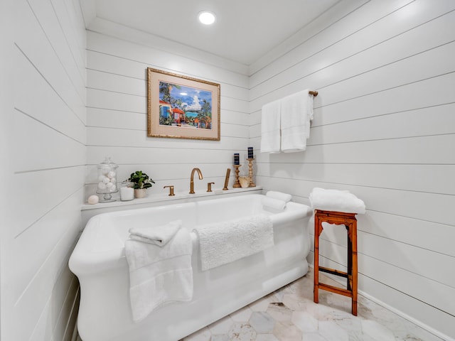 110 Gulf Shore Dr Unit 221, Destin, FL 32541 - bathroom featuring a freestanding tub, wood walls, marble look tiles, and recessed lighting