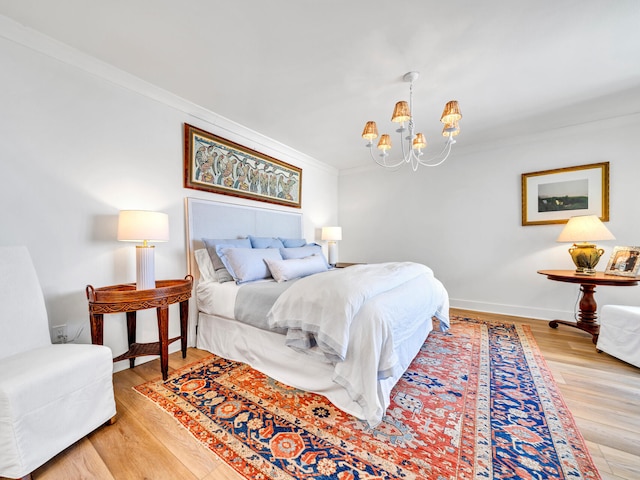 bedroom with wood-type flooring, a chandelier, and crown molding