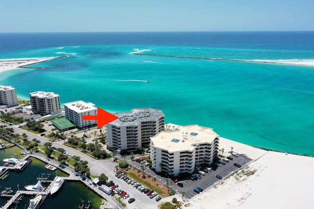 birds eye view of property with a beach view and a water view