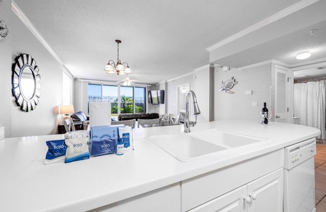 kitchen with ornamental molding, sink, white dishwasher, and a textured ceiling