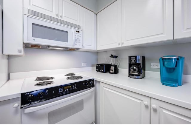 520 Santa Rosa Blvd Unit 100, Fort Walton Beach, FL 32548 - kitchen featuring white appliances, white cabinets, and light countertops