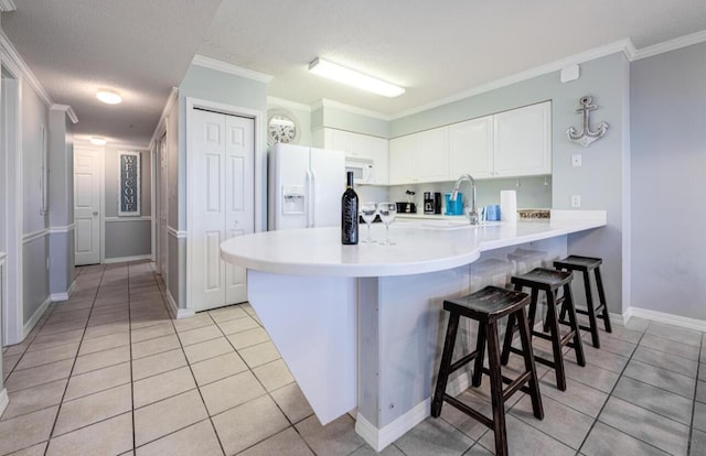 520 Santa Rosa Blvd Unit 100, Fort Walton Beach, FL 32548 - kitchen with white appliances, a peninsula, light tile patterned floors, a sink, and crown molding