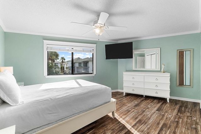 bedroom featuring a textured ceiling, ornamental molding, dark hardwood / wood-style floors, and ceiling fan